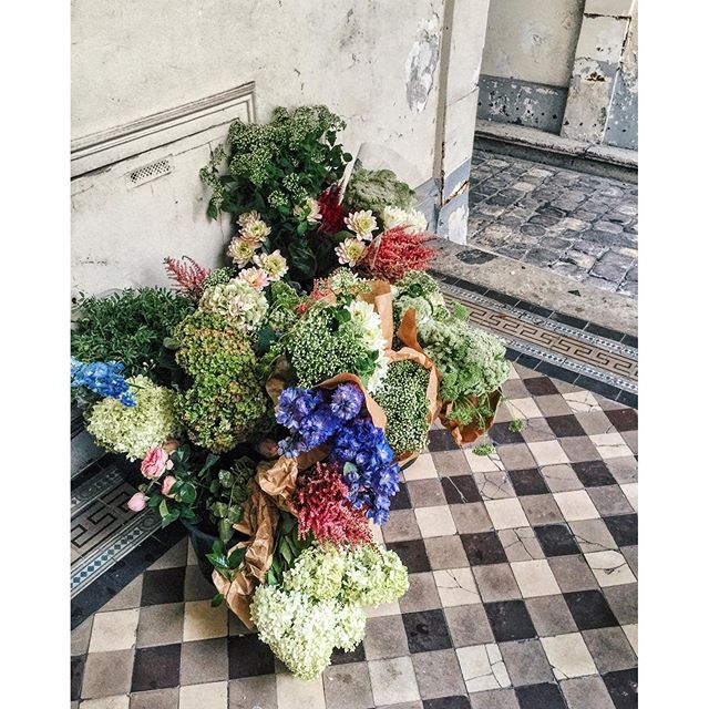 Cut to: MZ and team unconscious under a pile of flowers and hats post-production  